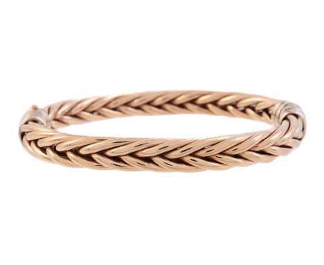
	
		A 9 CARAT GOLD TWO COLOUR WOVEN LINK BANGLE 
		The polished plaited wire to reeded concealed clasp and hinge section, pa