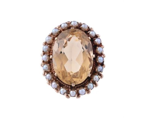 
	
		A CITRINE AND CULTURED PEARL CLUSTER RING 
		CIRCA 1970
		The oval cut citrine claw set within a surround of cultured pe