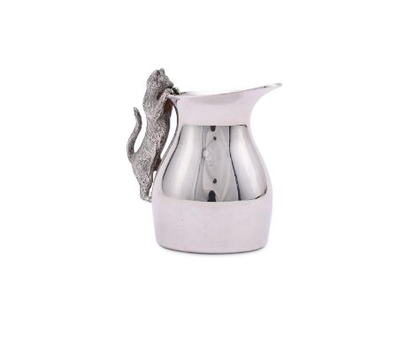 
	
		A SILVER CREAM JUG
		NICHOLAS PLUMMER, LONDON 2003
		With a cat handle
		7.5cm (3in) high
		173g (5.6 oz)
		
		Condition