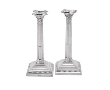 
	
		A PAIR OF SILVER CORINTHIAN CANDLESTICKS
		JAMES DIXON &amp; SONS, SHEFFIELD 1968
		With beaded sconces, chased acanthus