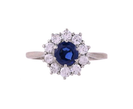 
	
		A SAPPHIRE AND DIAMOND CLUSTER RING 
		BIRMINGHAM 1971
		The central circular cut sapphire within a surround of brillian