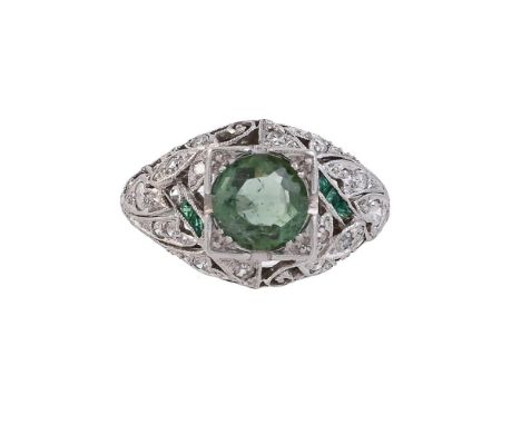 
	
		AN ART DECO EMERALD, DIAMOND AND GREEN TOURMALINE DRESS RING 
		CIRCA 1920
		The central circular cut green tourmaline i