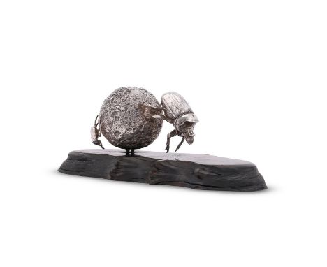 
	
		AN AFRICAN SILVER COLOURED MODEL OF A DUNG BEETLE
		PATRICK MAVROS, ZIMBABWE, MODERN
		Mounted on a shaped oval hardwood