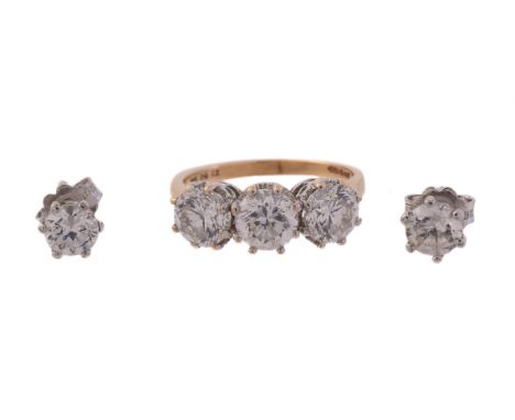 
	
		A CUBIC ZIRCONIA RING AND EAR STUDS
		The ring set with a trio or circular cut cubic zirconia, in claw settings, stamped