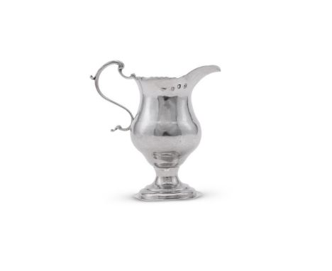 
	
		A GEORGE III SILVER CREAM JUG
		THOMAS WALLIS I, LONDON 1776
		With a shaped border, a leaf capped scroll handle, on a c