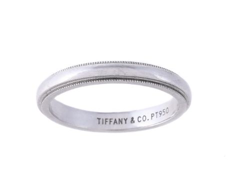 
	
		TIFFANY &amp; CO., A PLATINUM COLOURED BAND RING
		The polished band with millegrained borders, the shank stamped TIFFAN