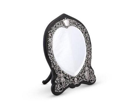 
	
		A VICTORIAN SILVER MOUNTED MIRROR
		WILLIAM COMYNS, LONDON 1886
		The border chased and pierced with foliage, knights, b