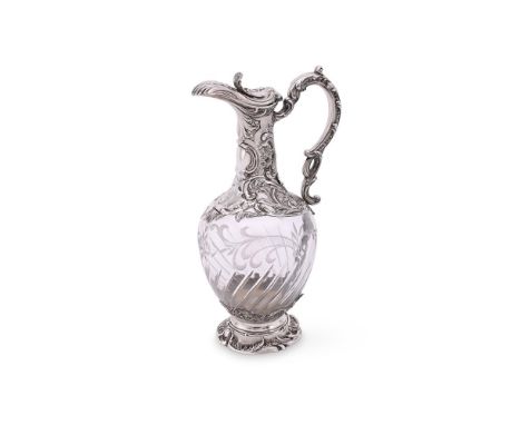 
	
		A FRENCH SILVER MOUNTED CLARET JUG
		MINERVA MARK
		With a foliate thumb piece to the cover, a foliate double scroll han