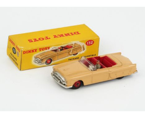 A Dinky Toys 132 Packard Convertible in light tan with red interior and hubs and grey driver in correct tan sticker colour sp