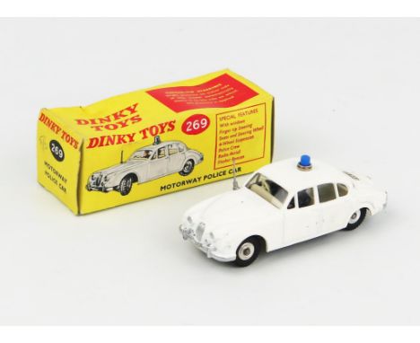 A Dinky Toys 269 Jaguar 3.4 Litre Motorway Police Car in matt white with light grey interior, blue roof light and spun hubs. 