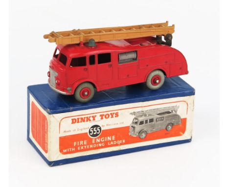 A Dinky Toys 555 (Commer) Fire Engine with Extending Ladder in red with tan ladder, no windows, red hubs and grey tyres in bl