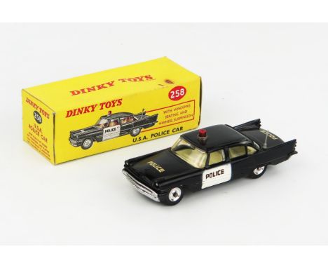 A Dinky Toys 258 Desoto Police Car in black with cream interior and red roof light. Excellent/near mint in  good+ box 