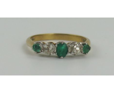 18ct Gold, Emerald and Diamond Five Stone Ring with a platinum claw setting, central stone c. 4.5x3.5mm, diamonds 3mm, size M