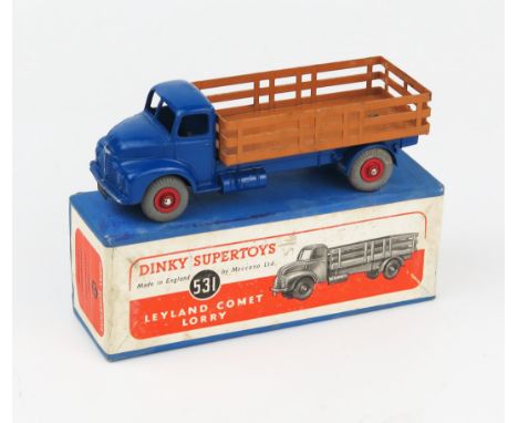 A Dinky Supertoys 531 Leyland Comet Lorry with Stake Body in dark blue with brown back, red hubs and grey tyres in blue box w