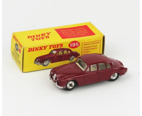 A Dinky Toys 195 Jaguar 3.4 Saloon in maroon with white interior, spun hubs and gloss black base in light yellow picture box 