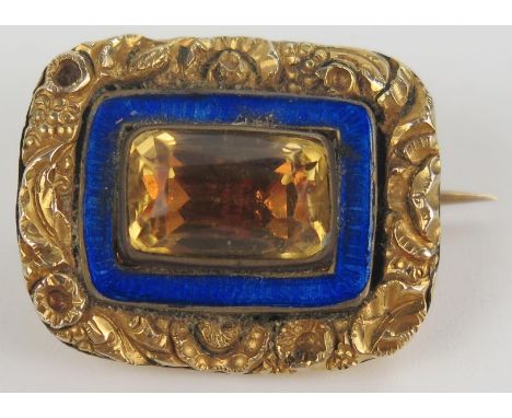 Georgian Unmarked Gold Brooch set with a foil backed citrine or paste and with a blue enamel surround, 24x19mm, 6.6g 