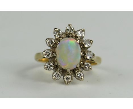 18ct Gold, Fire Opal And Diamond Cluster Ring, the central 8x7mm stone with a good range of reds, greens and blues, 16x14mm h