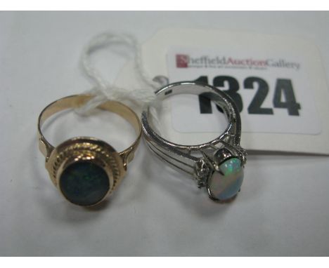 A Single Stone Opal Set Dress Ring, the central oval cabochon four claw set (indistinctly stamped), together with a single st