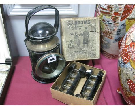 An Early XX Century Railway Lamp (only one of three rotational coloured filters), and a pair of Sandow's Grip Dumb Bells (poo