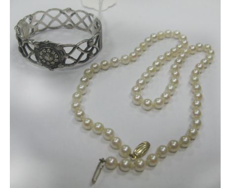 A Single Strand Uniform Pearl Bead Necklace; together with a hallmarked silver bangle, of openwork design, hinged to snap cla