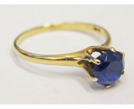 A yellow metal ring set with blue stone, marked '9ct', gross wt. 2.1g, size R.