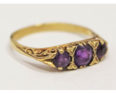 A hallmarked 9ct gold ring set with three amethyst coloured stones, gross wt. 2.9g, size Q.