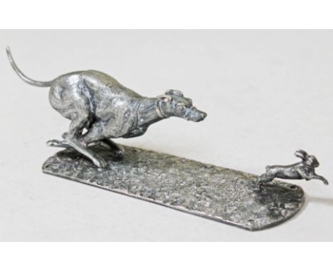 A silver plated model of a grey hound chasing a hare, unmarked, length 21cm. CONDITION REPORT - good, no damage/repair, gener