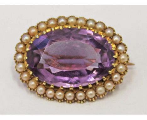 A Victorian yellow metal half cut pearl brooch set with a large amethyst colour stone, marked '15ct', length 2.6cm, gross wt.