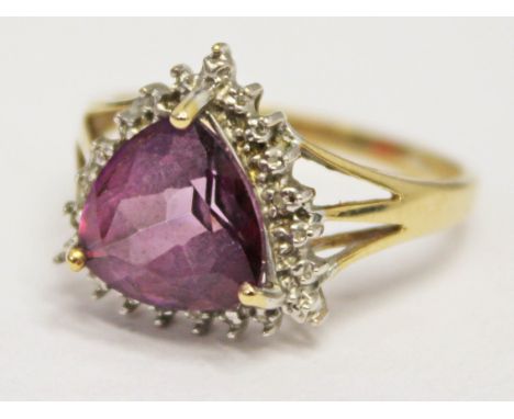 A hallmarked 9ct gold ring set with a purple stone, gross wt. 3.6g, size S.