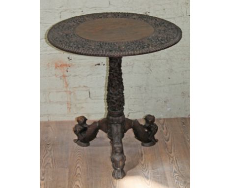 An Indian carved hardwood tripod table, diam. 68cm & height 70cm.