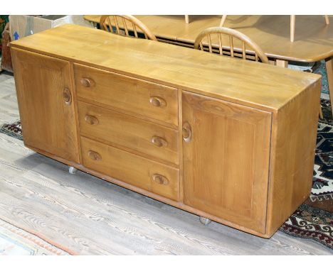 An Ercol blonde elm sideboard, length 156cm, depth 45cm & height 58.5cm.