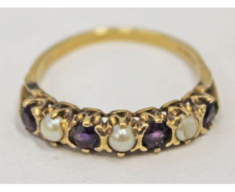 A hallmarked 9ct gold ring set with simulated pearls and purple stones, gross wt. 2.4g, size R.