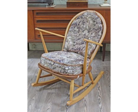 An Ercol blonde elm and beech rocking chair, width 69cm, depth 77cm & height 83cm.