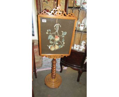 A Victorian mahogany pole screen with tapestry panel featuring pears. 