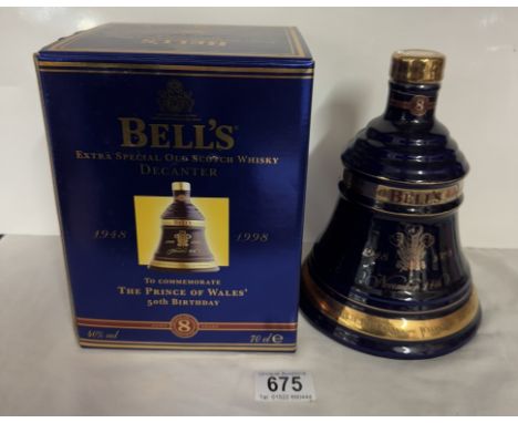 A boxed Bells extra special old Scotch whiskey decanter 'The Prince of Wales 50th birthday' (This bottle has slight leakage b