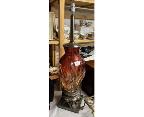 A tall red glass table lamp on metal base, will need re-wiring, (no shade)