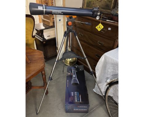 A boxed Celestron telescope 