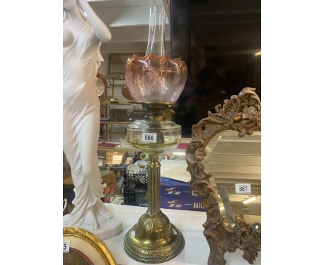 A Victorian brass oil lamp with faceted font &amp; art glass cranberry shade 