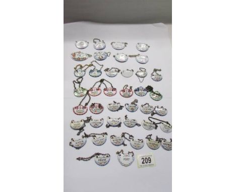 Forty antique enamel decanter labels. 