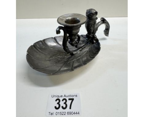 A 19th century silver plated base metal chamber candlestick with surmounted owl vesta 