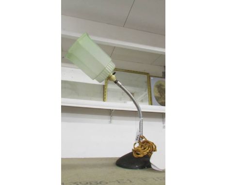 An art deco lamp with chrome flexible column and green glass shade. 