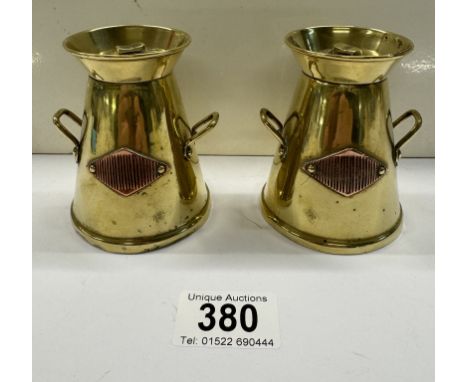 A pair of vintage brass milk churn match strikers 