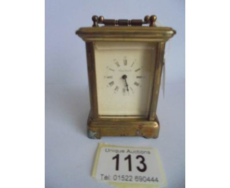 A miniature brass carriage clock marked 'London Clock Co.,' in working order.
