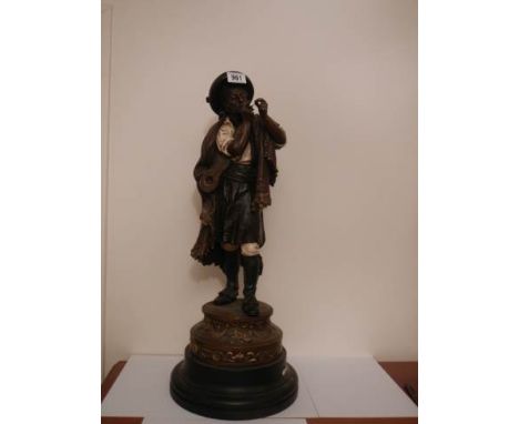 An early 20th century figure of a musician lighting a cigar, in good condition, 67 cm tall.