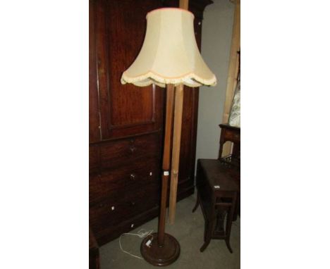 A mahogany standard lamp with shade. 