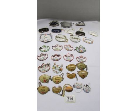 Thirty enamel decanter labels and three others. 