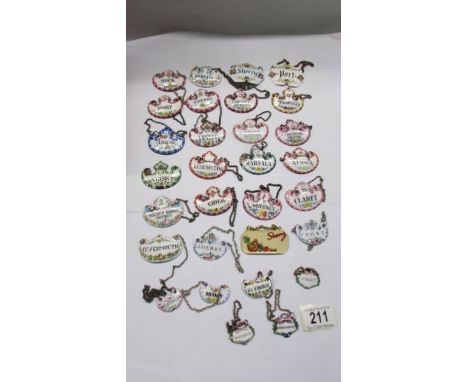 Thirty old enamel decanter labels. 