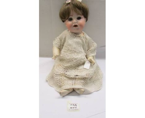 A German Armande Marsielle A-4-M 990 porcelain headed doll with composition body. 
