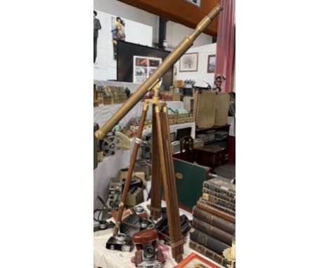 A large brass telescope on teak tripod 