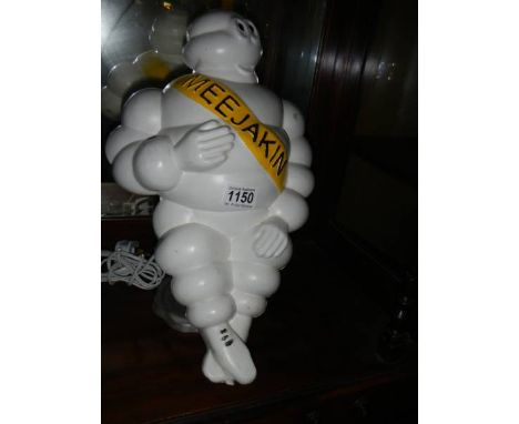 A vintage Michelin Man truck light mascot with Finnish branded sash, mounted as a table lamp, head to toe 42 cm.